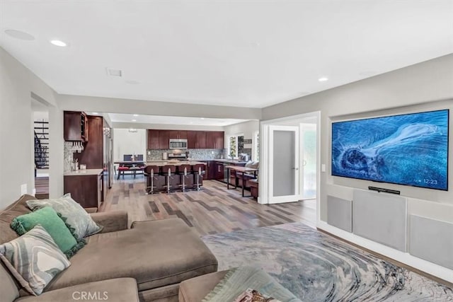 living area featuring light wood-style floors and recessed lighting