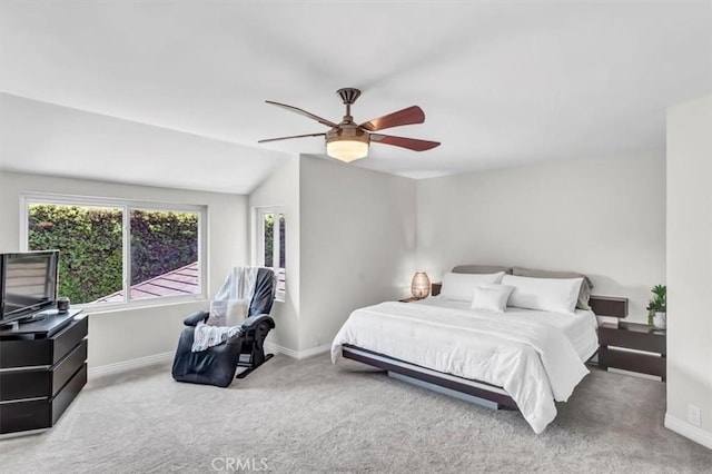 bedroom with vaulted ceiling, carpet flooring, a ceiling fan, and baseboards