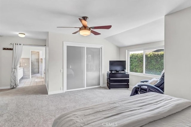 carpeted bedroom featuring baseboards, a ceiling fan, and ensuite bathroom