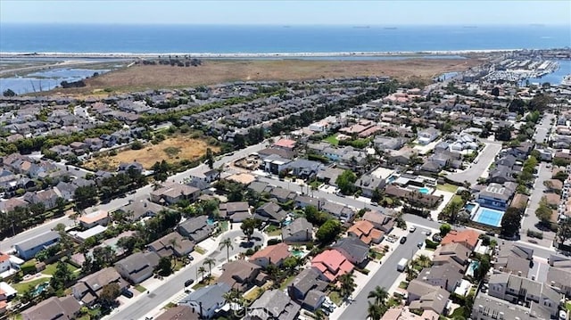 drone / aerial view with a residential view and a water view