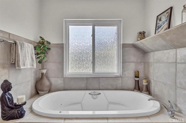 bathroom with a tub to relax in and plenty of natural light