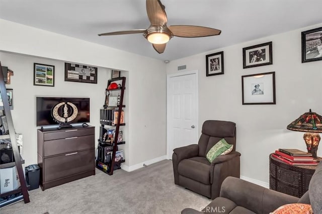 sitting room featuring a ceiling fan, carpet flooring, visible vents, and baseboards