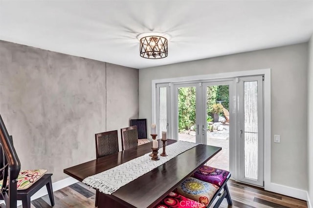 dining area featuring french doors, wood finished floors, and baseboards