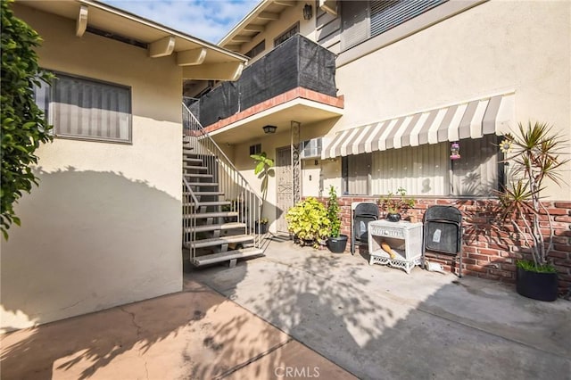 exterior space with a patio area and stucco siding