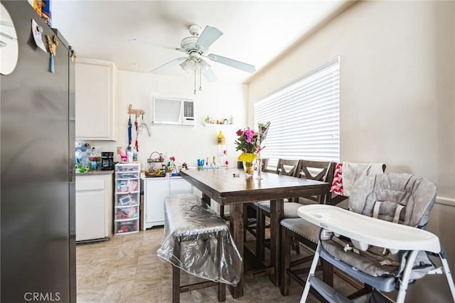 dining space featuring ceiling fan and an AC wall unit