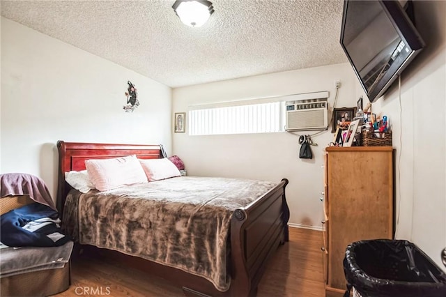 bedroom featuring a textured ceiling and wood finished floors