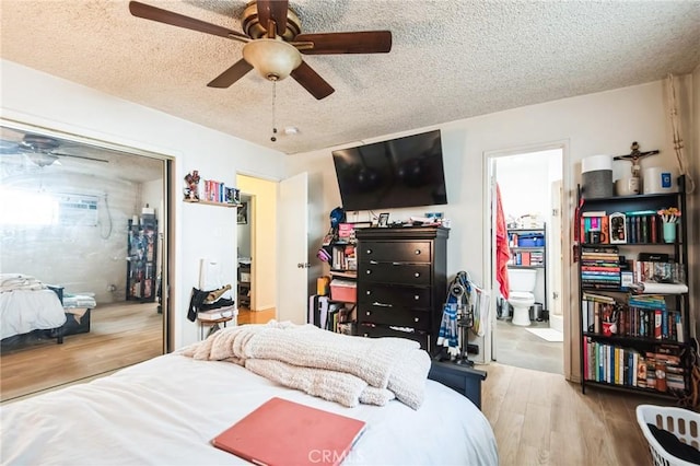 bedroom with ensuite bath, ceiling fan, a textured ceiling, and wood finished floors