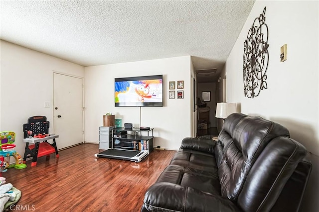 living area featuring a textured ceiling and wood finished floors