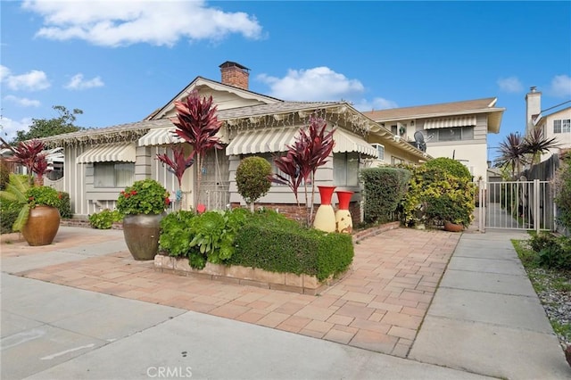 view of front of property featuring a gate and a chimney