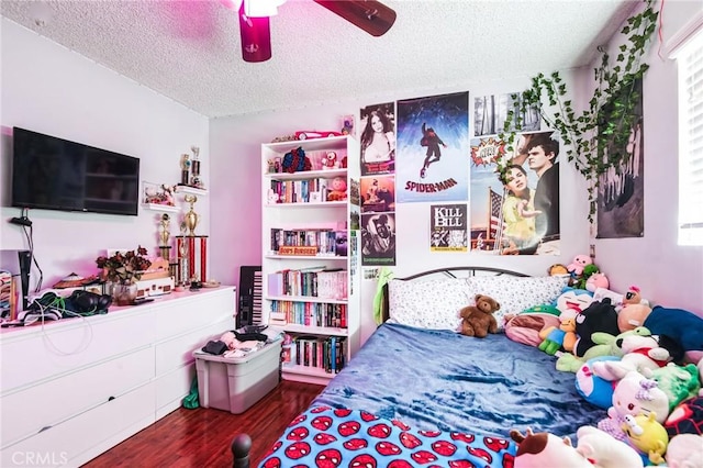 bedroom with ceiling fan, a textured ceiling, and wood finished floors