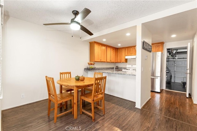 dining space featuring recessed lighting, dark wood-style flooring, and a textured ceiling