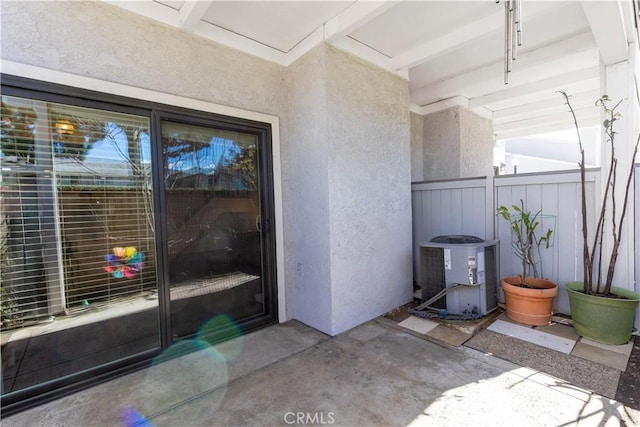 exterior space featuring fence and central AC unit