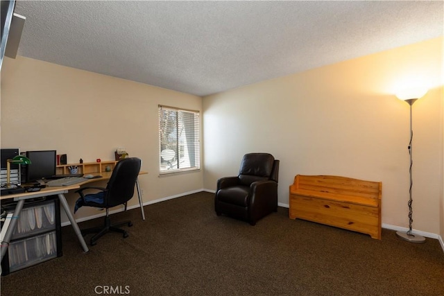 carpeted office featuring baseboards and a textured ceiling