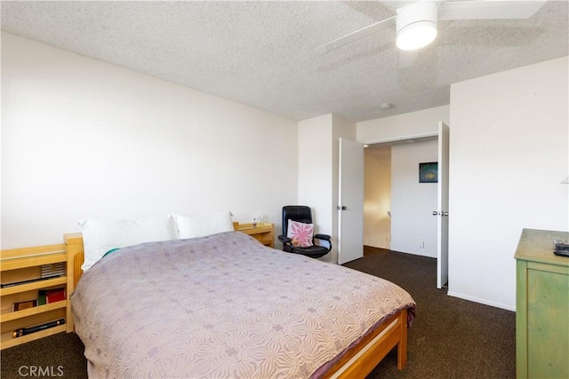 bedroom with a textured ceiling, ceiling fan, and carpet