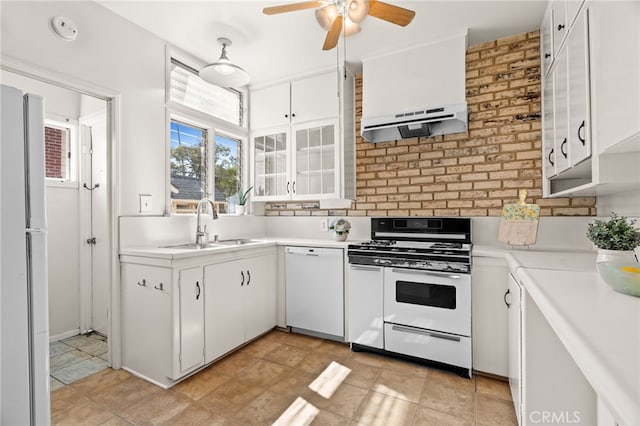 kitchen with under cabinet range hood, a sink, white cabinetry, white appliances, and light countertops