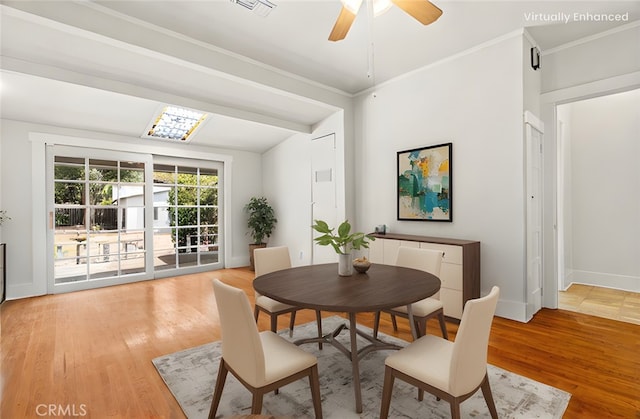 dining area featuring baseboards, light wood-style floors, ceiling fan, and crown molding