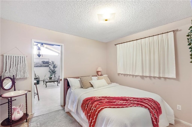 carpeted bedroom featuring a textured ceiling