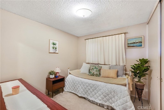 bedroom with a textured ceiling and carpet floors