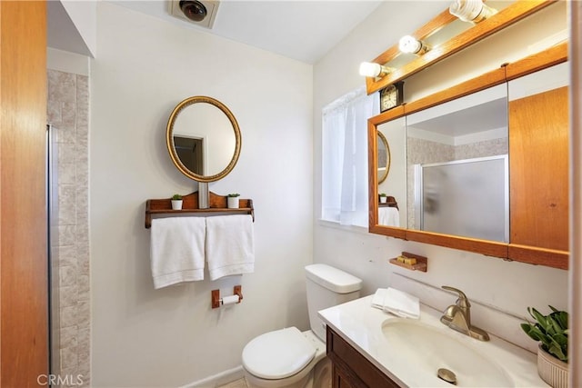 bathroom with toilet, a stall shower, visible vents, and vanity