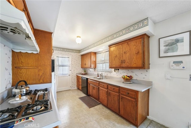 kitchen featuring a sink, light countertops, dishwasher, brown cabinetry, and wallpapered walls