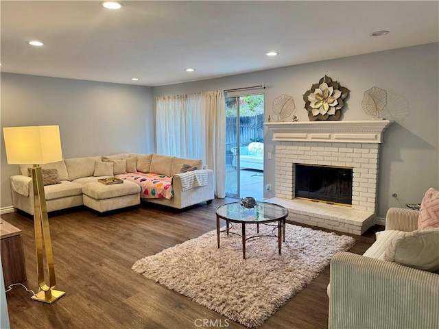 living room featuring dark wood-style floors, a fireplace, and recessed lighting