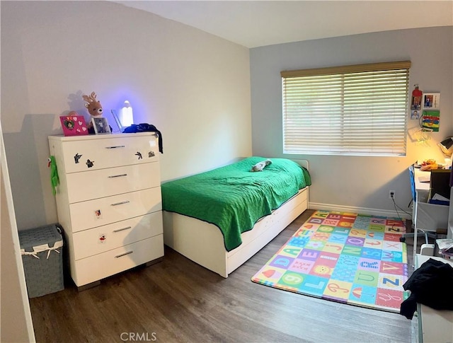 bedroom with wood finished floors and baseboards