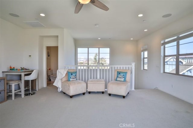 sitting room featuring ceiling fan, visible vents, recessed lighting, and carpet