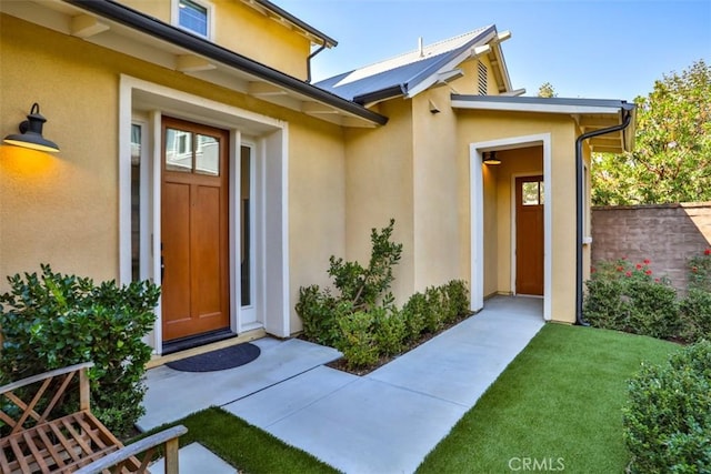 entrance to property with stucco siding