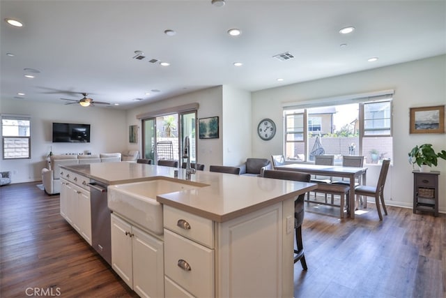 kitchen with a sink, dishwasher, visible vents, and open floor plan