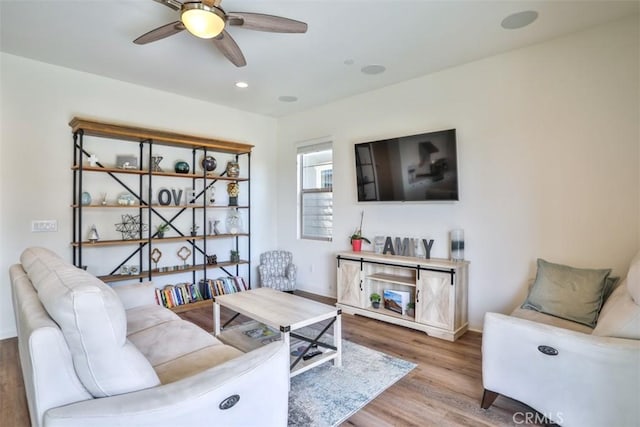living area with recessed lighting, baseboards, ceiling fan, and wood finished floors