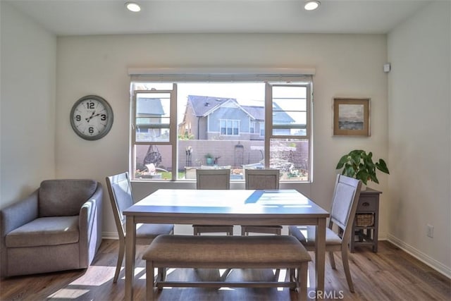 dining room with baseboards, wood finished floors, and recessed lighting