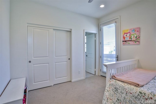 bedroom featuring light colored carpet, a closet, recessed lighting, and a ceiling fan
