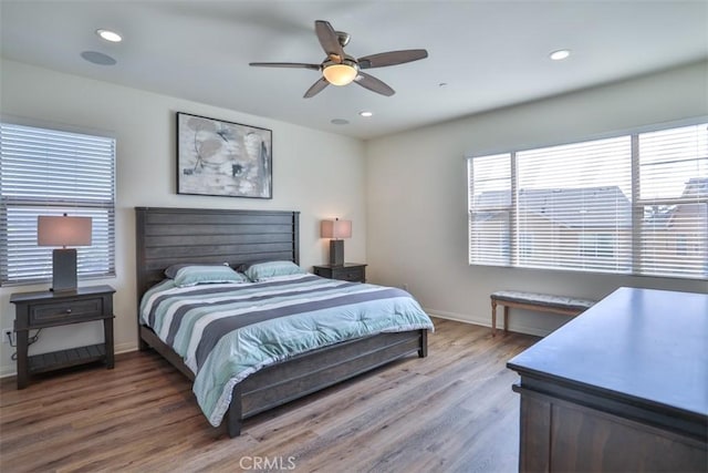 bedroom with baseboards, wood finished floors, recessed lighting, and a ceiling fan