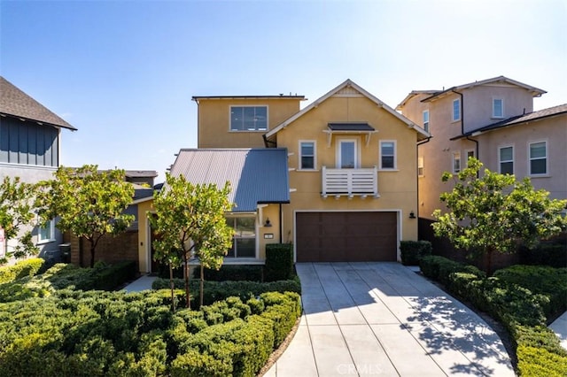 view of front of property with driveway, a garage, and stucco siding