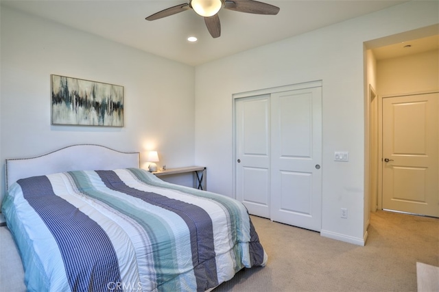 bedroom with a closet, a ceiling fan, baseboards, light colored carpet, and recessed lighting