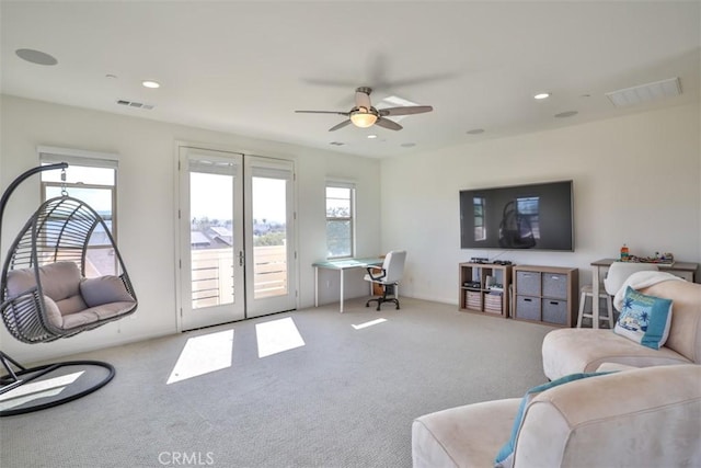 living room with carpet floors, ceiling fan, visible vents, and french doors