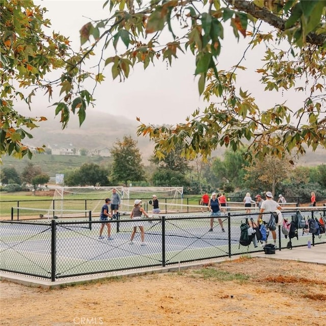 view of sport court with fence