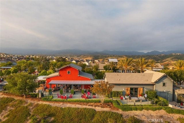 rear view of property with a mountain view and a patio area