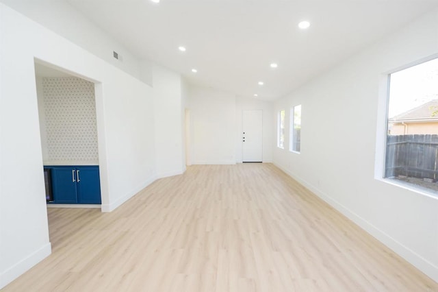 spare room featuring light wood-type flooring, recessed lighting, visible vents, and baseboards