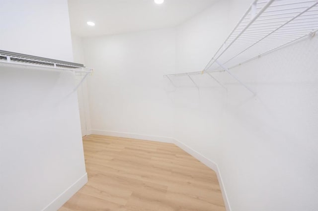 walk in closet featuring light wood finished floors