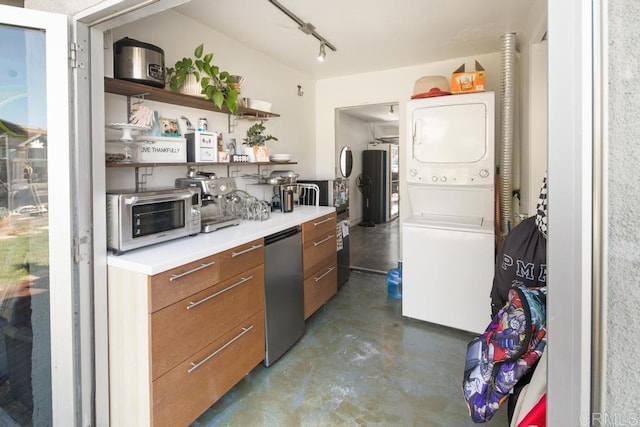 kitchen with brown cabinets, open shelves, stacked washer and dryer, light countertops, and concrete floors