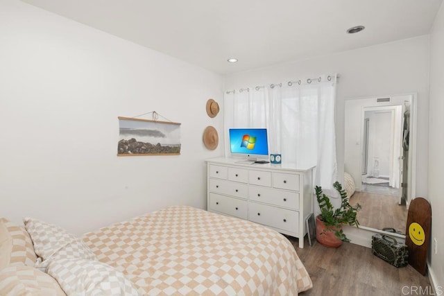 bedroom with wood finished floors, visible vents, and recessed lighting