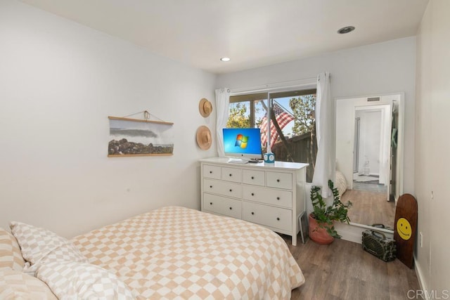 bedroom with visible vents, wood finished floors, and recessed lighting