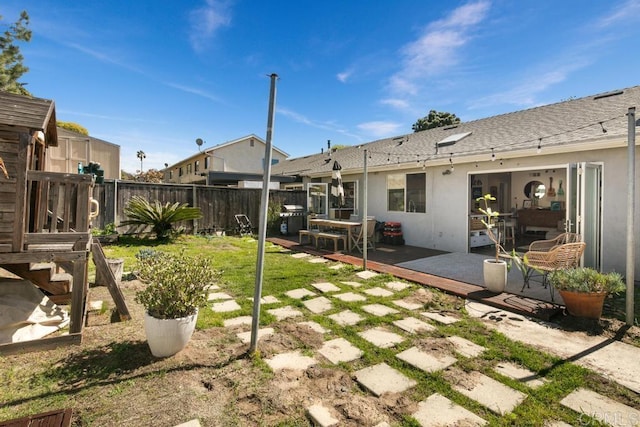 view of yard with fence and a deck