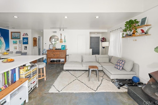 living room with recessed lighting and finished concrete floors