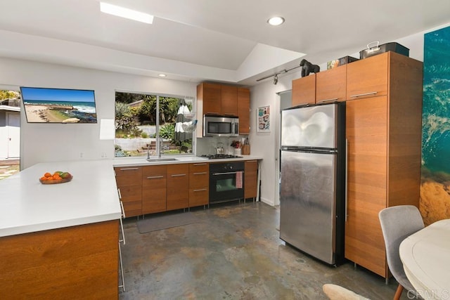 kitchen with brown cabinets, stainless steel appliances, recessed lighting, light countertops, and concrete flooring