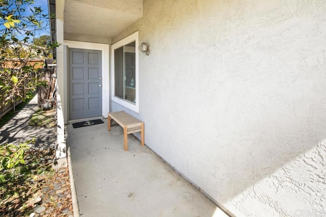 entrance to property with stucco siding