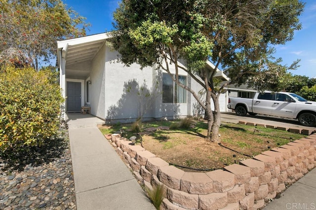 view of property exterior featuring driveway and stucco siding