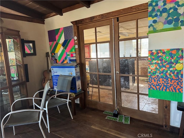 interior space with lofted ceiling with beams and wood finished floors