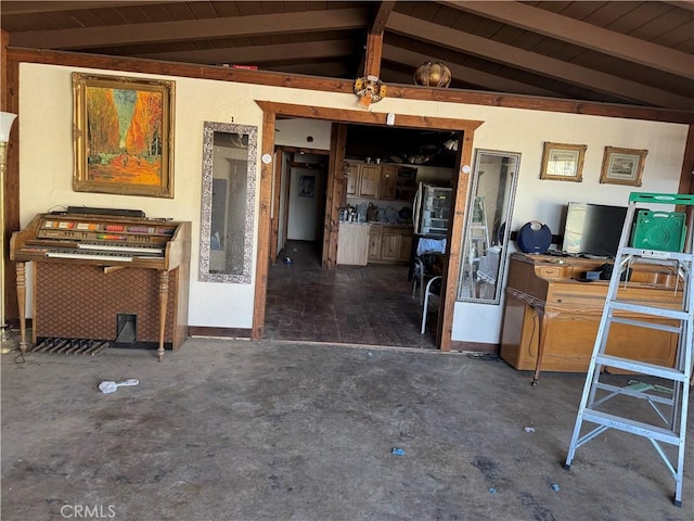 miscellaneous room featuring lofted ceiling with beams and baseboards